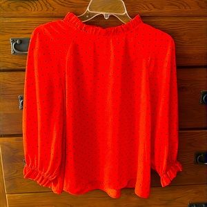 Blouse red with black polka dots.